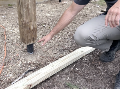 Professional Inspecting Deck Post Installed With A Helical Pile