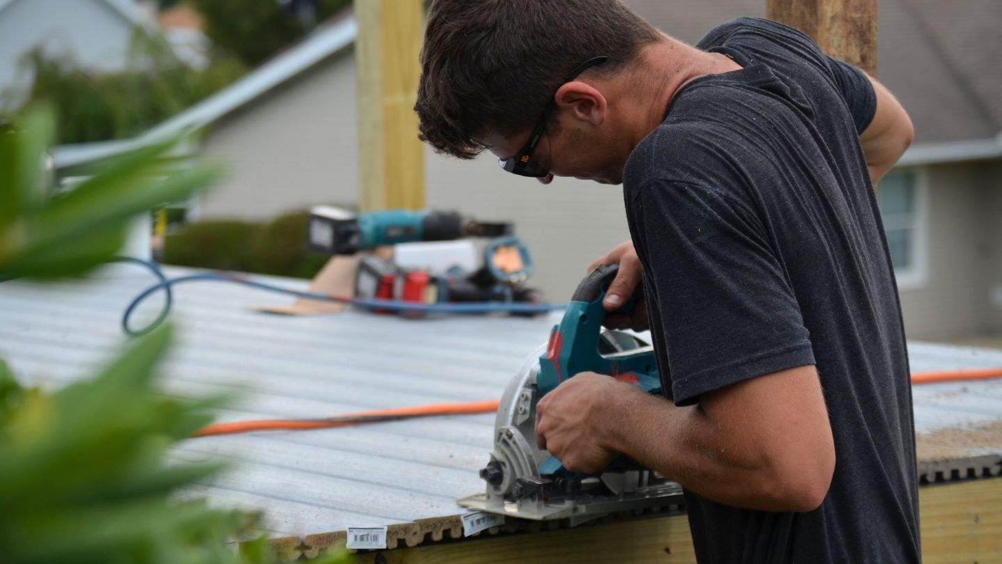 Person Using Circular Saw For Deck Construction 