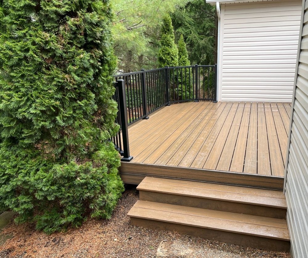 Trex Decking With Black Railings And Wooden Steps