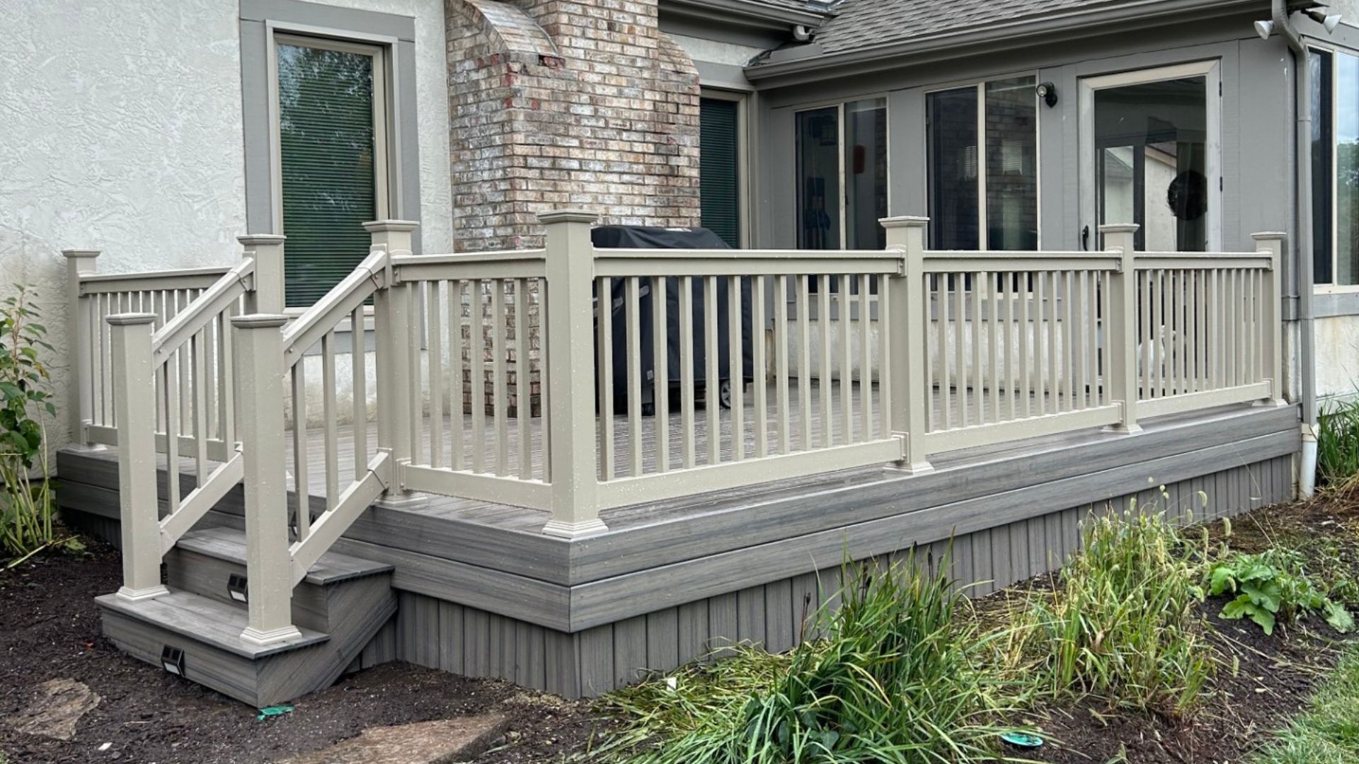 Outdoor Patio With Wooden Pergola And Stone Columns By Water