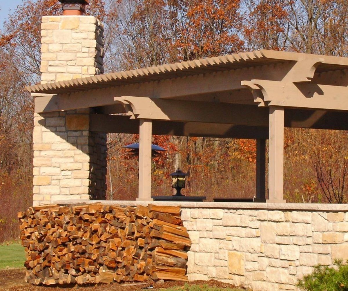 Outdoor Fireplace With A Wooden Patio Cover