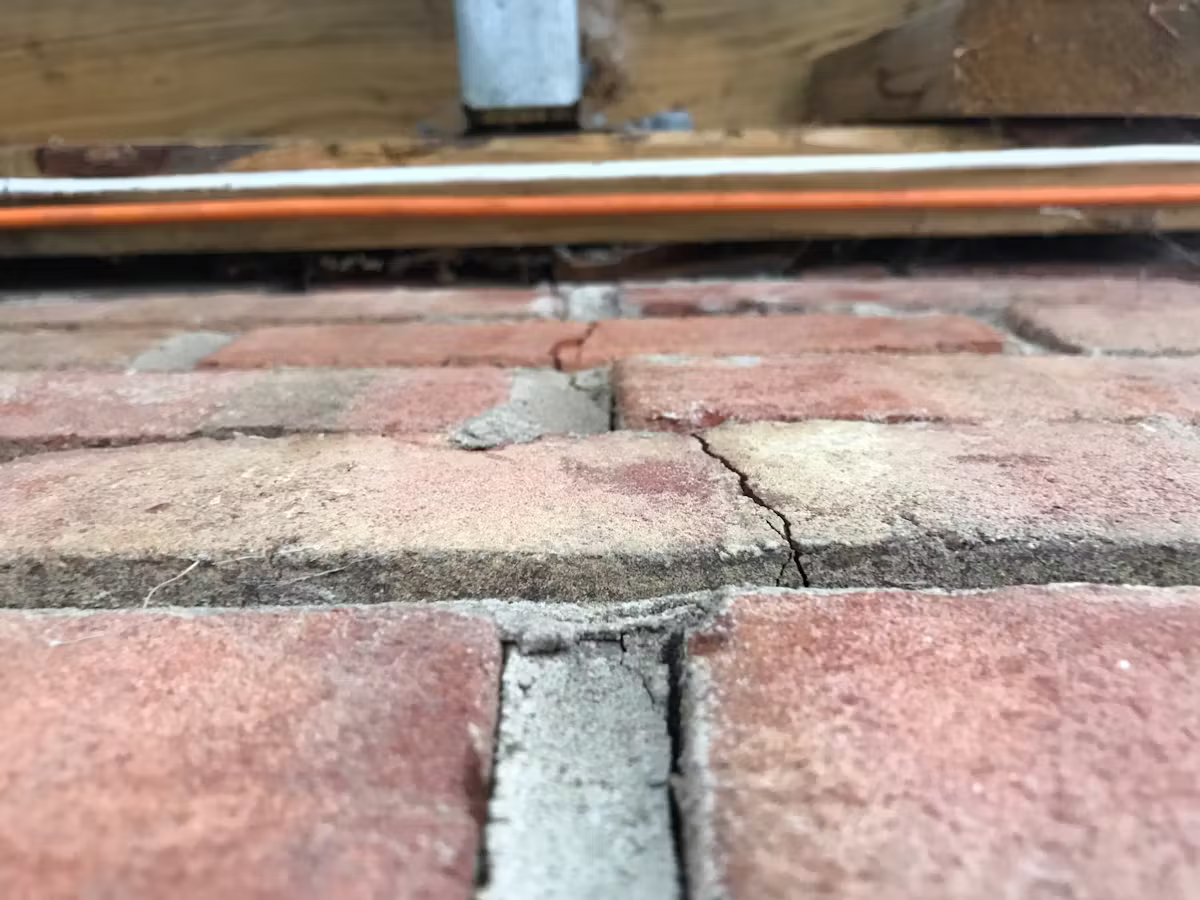 Cracked Brick Pavers On Outdoor Patio Surface